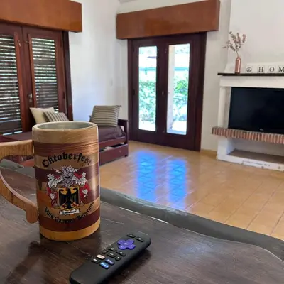 a remote control sitting on a table in a living room at Amplia casa a solo unos metros del centro - RentVGB in Villa General Belgrano