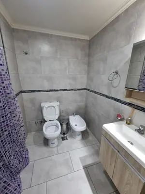 a bathroom with a toilet and a sink at Depto triplex frente el lago in Villa Carlos Paz