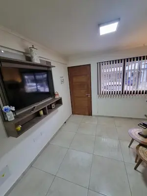 a living room with a flat screen tv on a wall at Depto triplex frente el lago in Villa Carlos Paz
