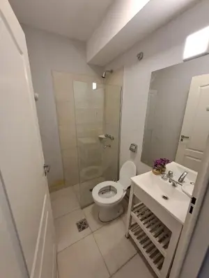 a bathroom with a toilet and a shower and a sink at Baumhaus in Villa Anizacate
