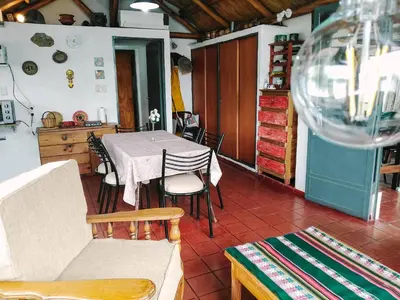 a dining room with a table and chairs at Casa con vista al lago en Potrero de Garay in La Estancia