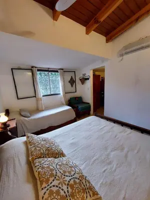 a bedroom with a large bed and a window at Casa con vista al lago en Potrero de Garay in La Estancia