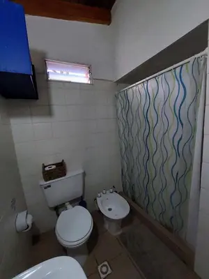 a bathroom with a toilet and a sink at Casa con vista al lago en Potrero de Garay in La Estancia