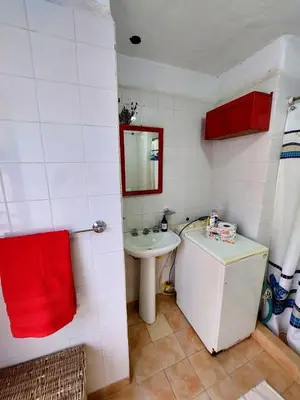 a small bathroom with a sink and a mirror at Casa con vista al lago en Potrero de Garay in La Estancia