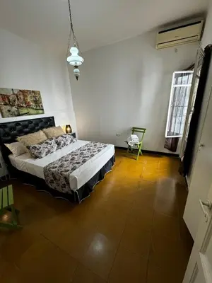 a bedroom with a bed and a chair in it at Departamento de Santa Rosa in Cordoba