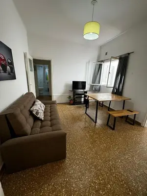 a living room with a couch and a table at Departamento de Santa Rosa in Cordoba