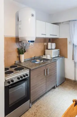 a kitchen with a stove and a sink at Trejo 351 in Cordoba