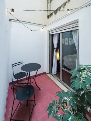 a patio with a table and two chairs and a window at Trejo 351 in Cordoba
