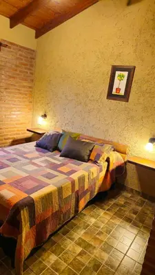 a bedroom with a bed in a room at Departamentos Atardecer Serrano in Arroyo de Los Patos