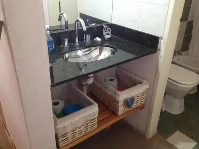 a bathroom with a sink and a toilet at Cabaña La Lechuza en LAS RABONAS in Mina Clavero