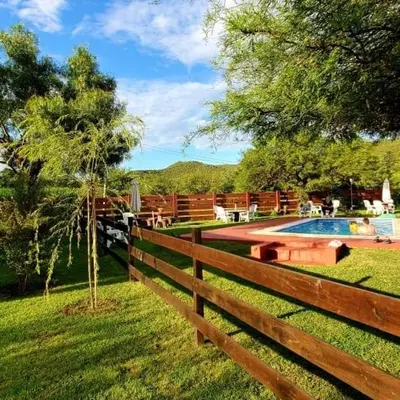 a wooden fence next to a swimming pool at Cabañas Ipachi Naguan in Villa Rumipal