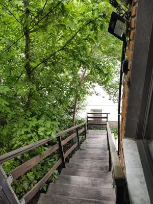 a wooden walkway with a bench in a park at AMABLEs in Salsacate