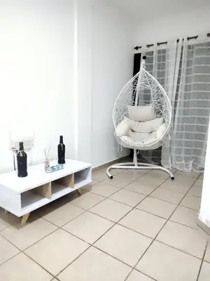 a white room with a hanging chair with pillows at Dpto Nuevocentro Shopping CON ESTACIONAMIENTO GRATUITO in Cordoba