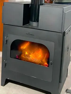 a stove with a fire inside of it at Duplex del Bosque - Solo Parejas in Mina Clavero