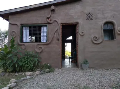 a house with a door and a window at Cabaña El Colibri en Villa Amancay in Villa Amancay