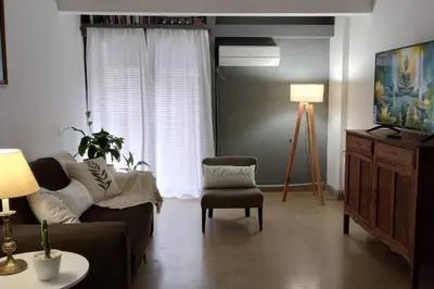 a living room with a couch and a chair at Spacious bright apartment with garage in Cordoba in Cordoba