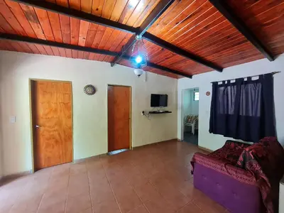 a living room with a couch and a wooden ceiling at Cabañas los Nonitos in Villa Los Aromos
