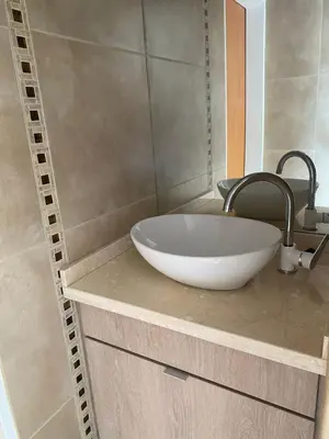 a bathroom with a white bowl sink on a counter at Apart de Sierras in Nono