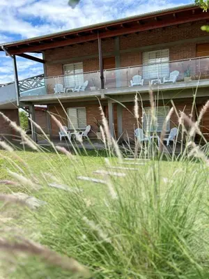 a house with chairs on the porch of it at Apart de Sierras in Nono