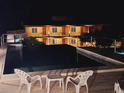 two chairs and a table on a patio at night at Apart de Sierras in Nono