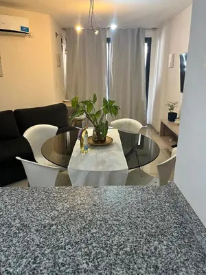 a living room with a table and chairs at Departamento en Nueva Cordoba in Cordoba