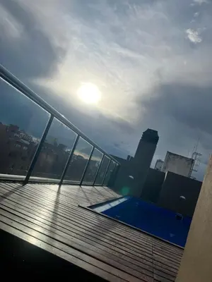 a rooftop deck of a building with a swimming pool at Departamento en Nueva Cordoba in Cordoba