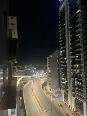 a city street at night with buildings and street lights at Departamento en Nueva Cordoba in Cordoba