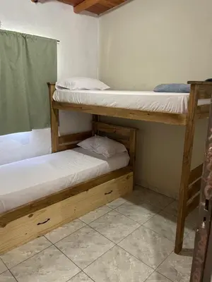 two bunk beds in a small room with at Cabañas D Noris in Los Hornillos