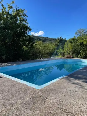 a swimming pool in the middle of a gravel yard at Cabañas D Noris in Los Hornillos