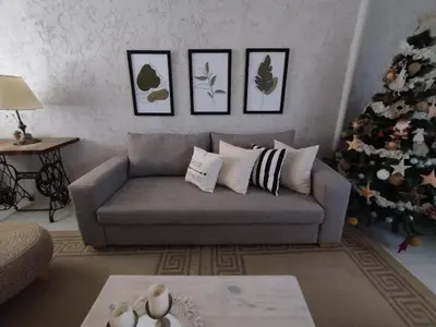 a living room with a couch and a christmas tree at Casa Privada Carlos Paz con piscina a dos cuadras del rio in Villa Carlos Paz