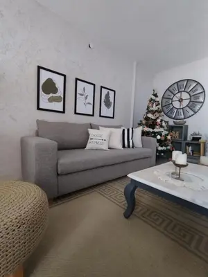 a living room with a couch and a christmas tree at Casa Privada Carlos Paz con piscina a dos cuadras del rio in Villa Carlos Paz