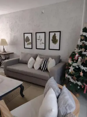 a living room with a couch and a christmas tree at Casa Privada Carlos Paz con piscina a dos cuadras del rio in Villa Carlos Paz