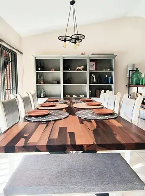 a dining room with a large wooden table and chairs at Casa Privada Carlos Paz con piscina a dos cuadras del rio in Villa Carlos Paz