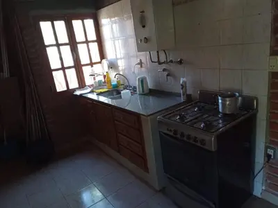 a kitchen with a stove and a sink at Amables 2 in Salsacate