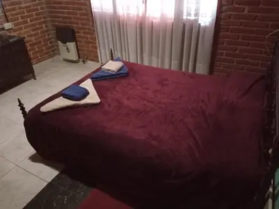 a large red bed with two towels on top of it at Amables 2 in Salsacate