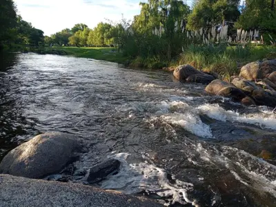 a river with rocks on the side of it at Amables 2 in Salsacate