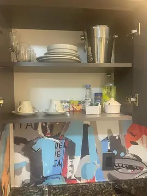 a shelf with plates and dishes in a kitchen at Departamento 105 - Edificio VILAUT by INMOVE Temporarios in Cordoba