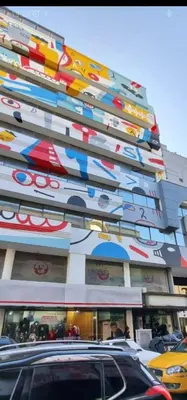 a building with colorful umbrellas on the side of it at Departamento 105 - Edificio VILAUT by INMOVE Temporarios in Cordoba