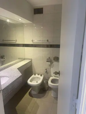 a bathroom with a toilet and a bidet and a sink at Departamento 105 - Edificio VILAUT by INMOVE Temporarios in Cordoba