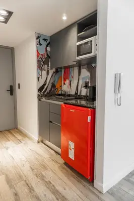 a kitchen with a red refrigerator in a room at Departamento 110 - Edificio VILAUT by INMOVE Temporarios in Cordoba