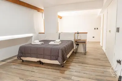a bedroom with a bed and a desk in it at Departamento 110 - Edificio VILAUT by INMOVE Temporarios in Cordoba