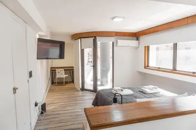 a small room with two beds and a television at Departamento 110 - Edificio VILAUT by INMOVE Temporarios in Cordoba