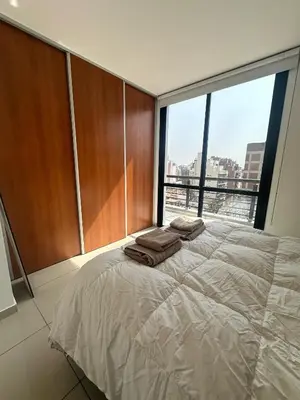 a bedroom with a large bed with towels on it at Buen Pastor Design in Cordoba