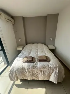 a bedroom with a bed with two towels on it at Buen Pastor Design in Cordoba