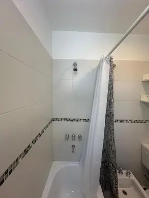 a white bathroom with a tub and a shower at Buen Pastor Design in Cordoba