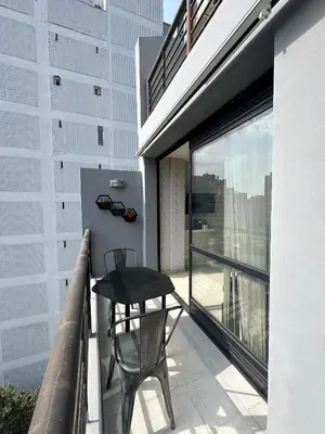 a balcony with a table and chair on a building at Buen Pastor Design in Cordoba