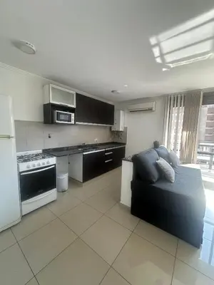 a large kitchen with a couch in a room at Buen Pastor Design in Cordoba