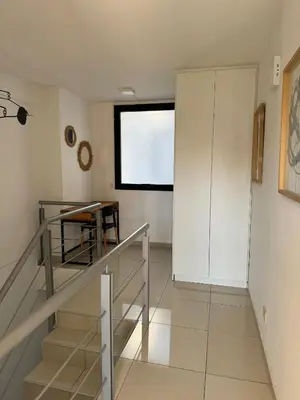 a room with stairs and a table and a window at Buen Pastor Design in Cordoba