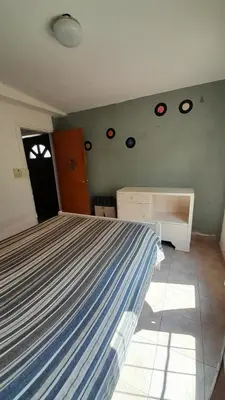 a bedroom with a large bed and a window at Departamento Nini Villa Del Dique in Villa del Dique