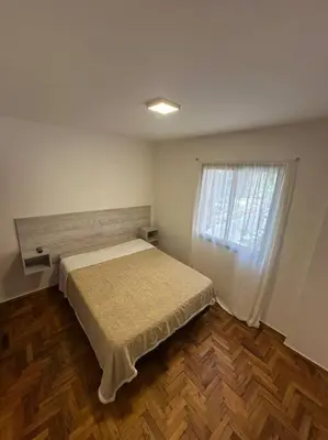 a small bedroom with a bed and a window at Rondeau Suite in Cordoba